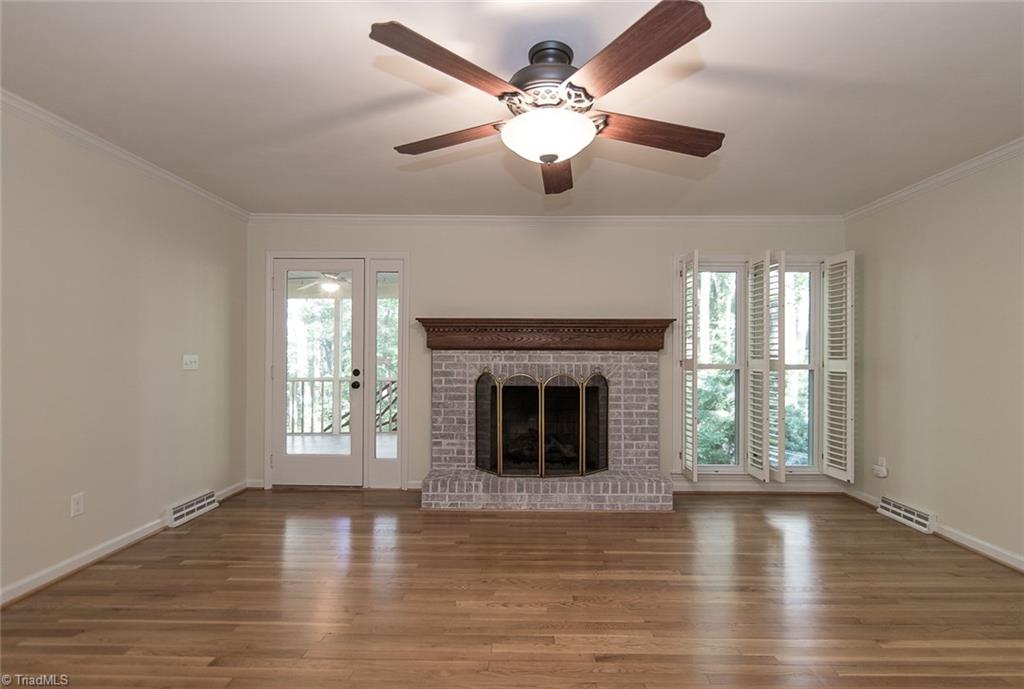 5317 Tower Road Greensboro, NC 27410 - Photo 6 of 30 Den with fireplace and plenty of natural light.