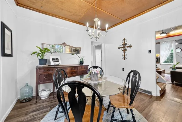 a view of a dining room with furniture and chandelier