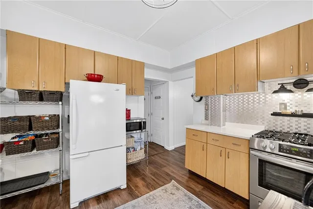 a white refrigerator freezer sitting in a kitchen