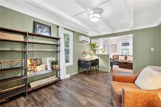 a living room with furniture and a wooden floor
