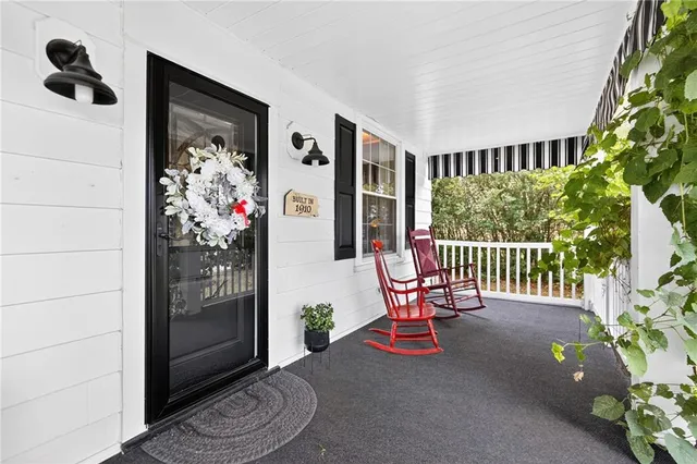 a view of a livingroom with furniture and floor to ceiling window