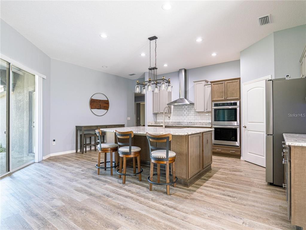 10688 Southwest 129th Terrace Road Dunnellon, FL 34432 - Photo 8 of 35 a large kitchen with a table and chairs