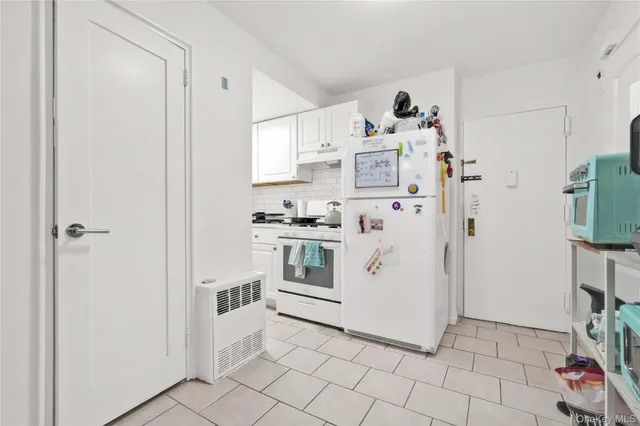 a bathroom with granite countertop toilet sink and mirror