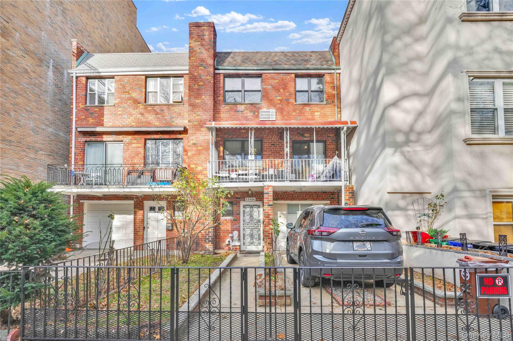a view of a brick house with large windows