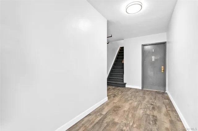 a living room with furniture a flat screen tv and a window