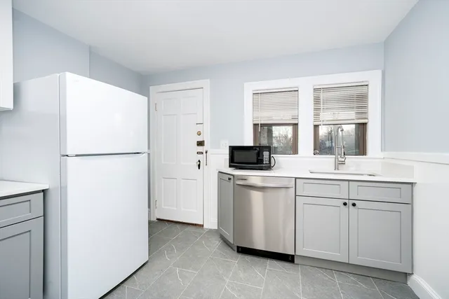 a kitchen with a sink and refrigerator