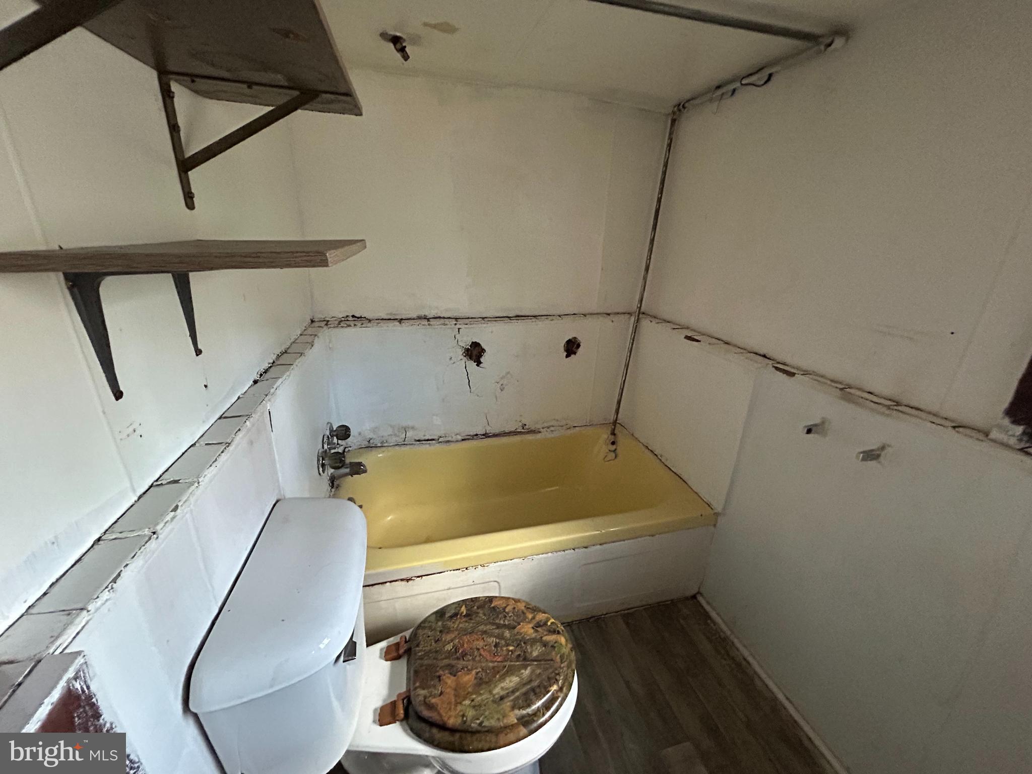 1773 Spruce Street Madera, PA 16661 - Photo 3 of 7 a bathroom with a toilet a sink and bathtub
