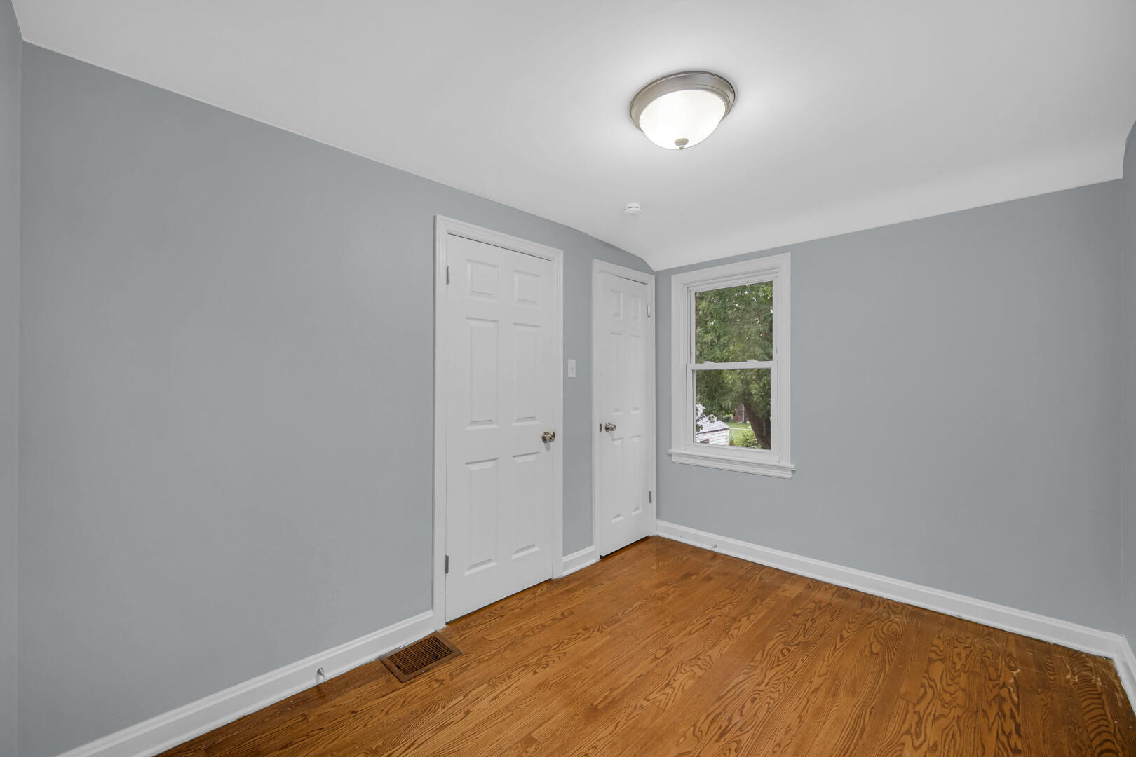 4810 Monroe Street Gary, IN 46408 - Photo 15 of 19 a view of an empty room with a window and wooden floor