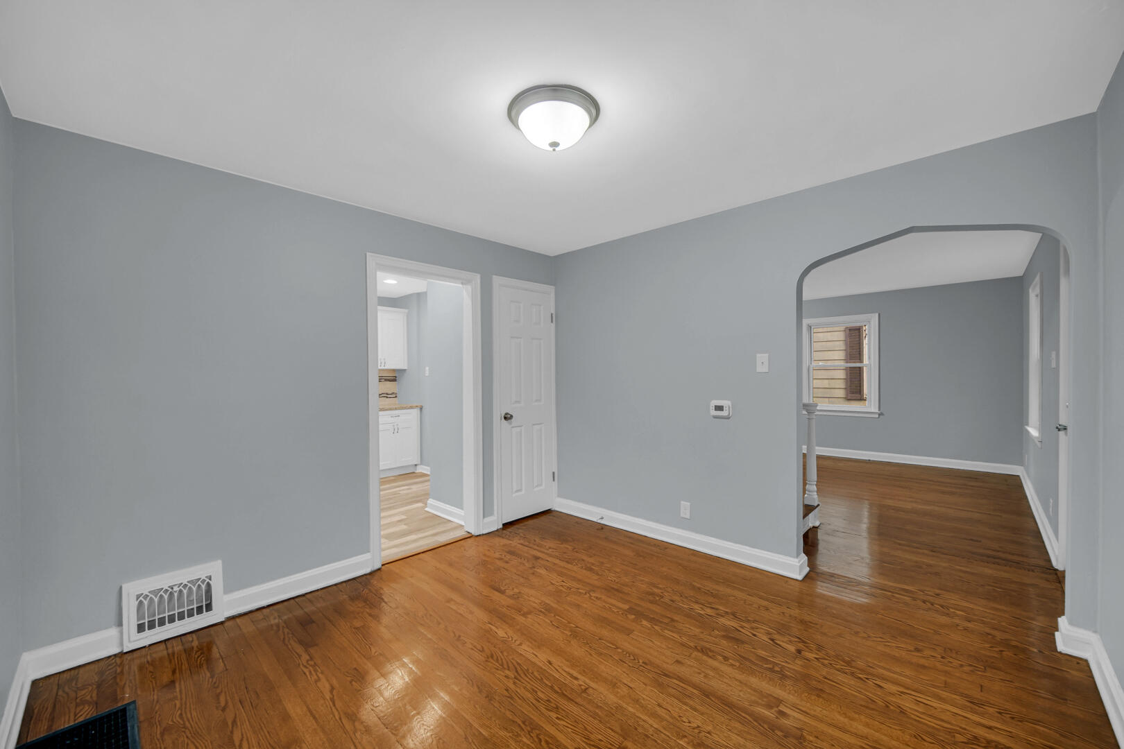 4810 Monroe Street Gary, IN 46408 - Photo 2 of 19 a view of an empty room with wooden floor and a window