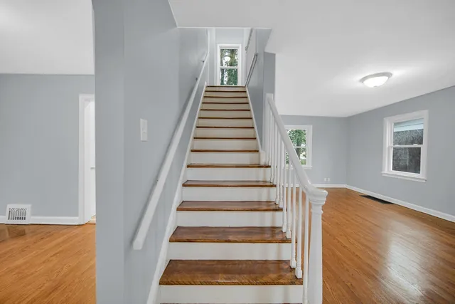 a view of entryway and hall with wooden floor
