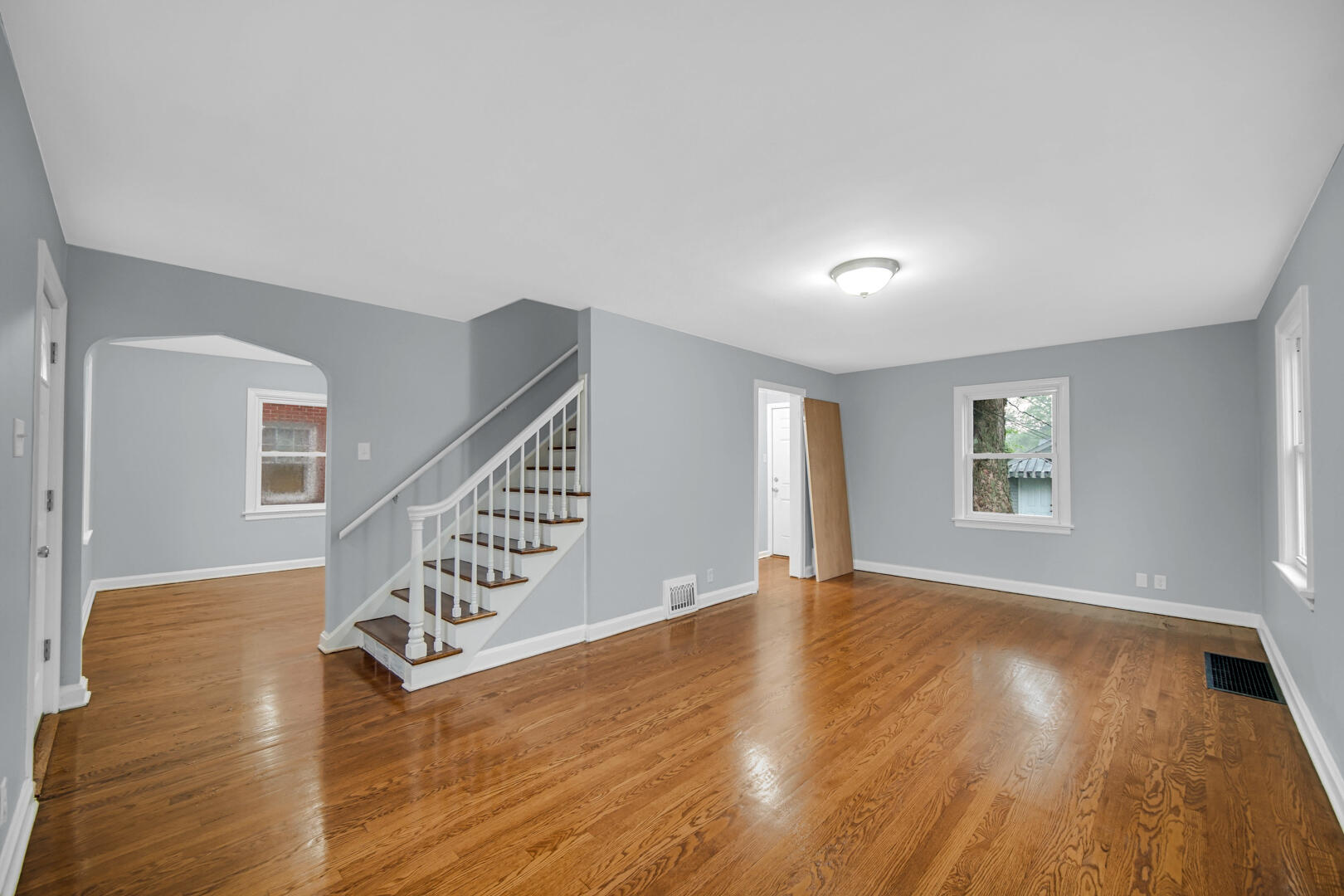 4810 Monroe Street Gary, IN 46408 - Photo 9 of 19 a view of an empty room with wooden floor and windows