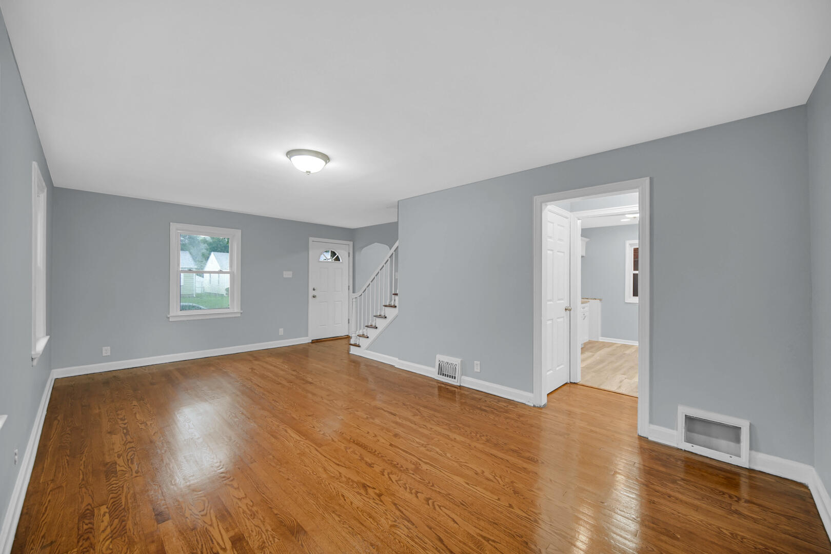 4810 Monroe Street Gary, IN 46408 - Photo 10 of 19 a view of an empty room with wooden floor and a window