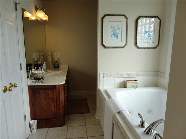 6153 Lakeview Road Springfield, TN 37172 - Photo 10 of 16 Master bath with garden whirlpool tub, separate shower, ceramic tile flooring, and his and her vanities.
