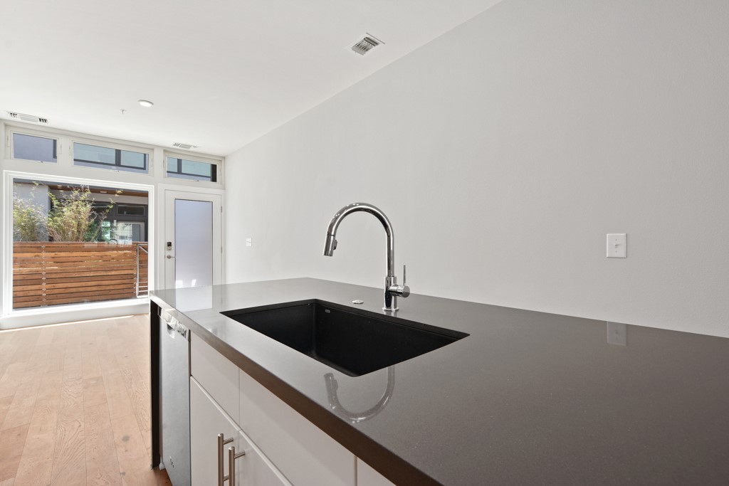 2002 East 7th Street, Unit 246 Austin, TX 78702 - Photo 12 of 25 a kitchen with a sink and a refrigerator
