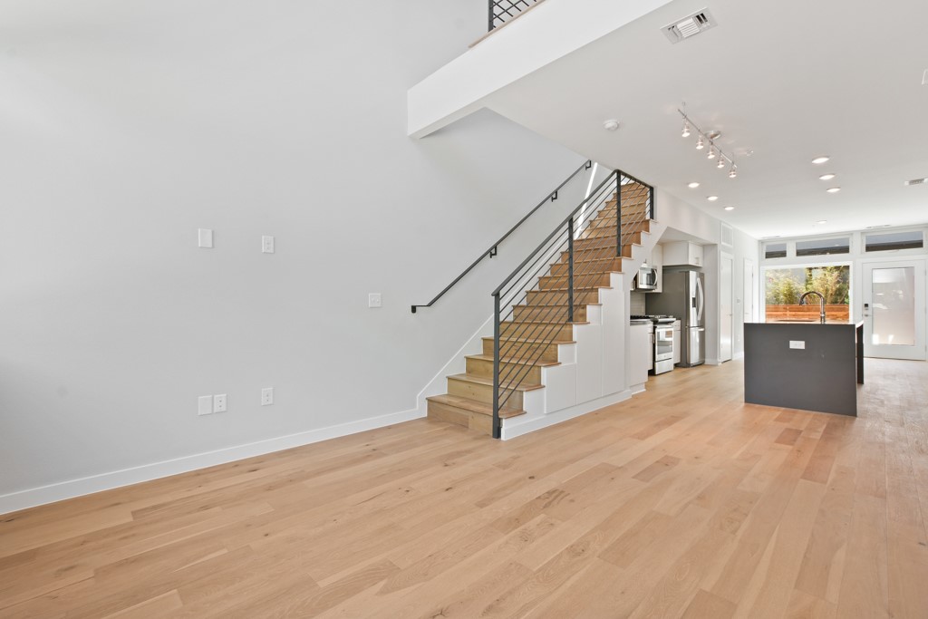 2002 East 7th Street, Unit 246 Austin, TX 78702 - Photo 15 of 25 a view of an empty room with wooden floor and stairs
