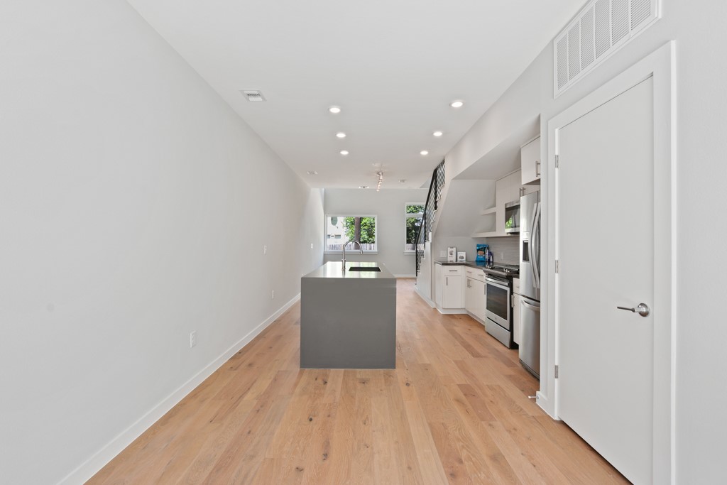 2002 East 7th Street, Unit 246 Austin, TX 78702 - Photo 8 of 25 a view of a kitchen with wooden floor