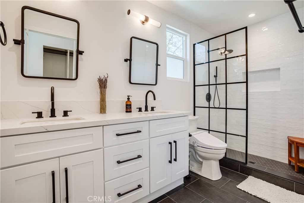 517 Davis Avenue Glendale, CA 91201 - Photo 14 of 18 a bathroom with a toilet sink double mirror and vanity