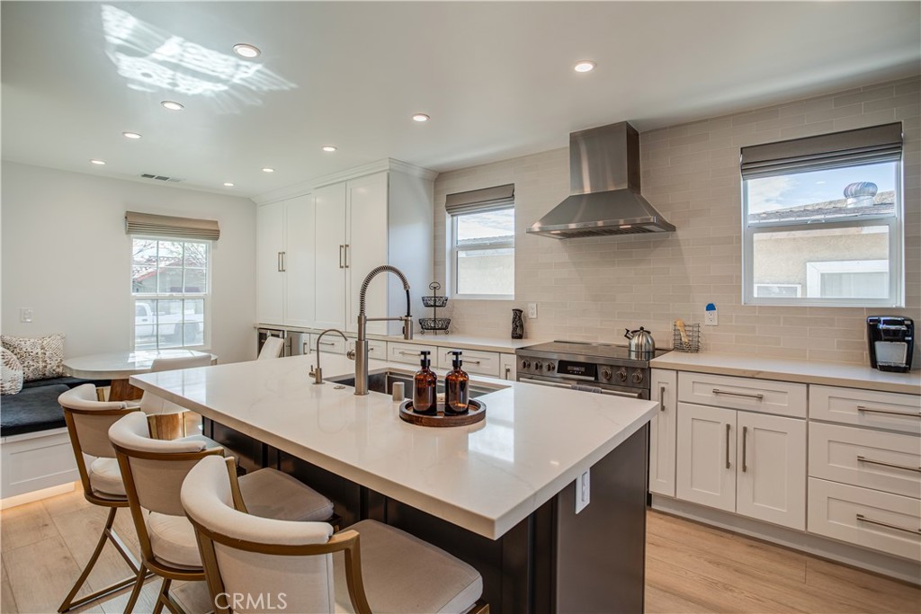 517 Davis Avenue Glendale, CA 91201 - Photo 4 of 18 a kitchen with stainless steel appliances granite countertop a sink a stove a dining table and chairs