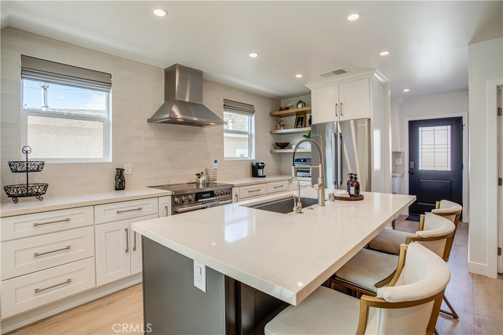 517 Davis Avenue Glendale, CA 91201 - Photo 6 of 18 a kitchen with stainless steel appliances a table chairs refrigerator and cabinets