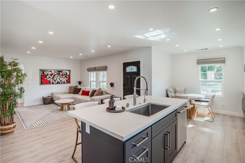 517 Davis Avenue Glendale, CA 91201 - Photo 8 of 18 a kitchen with a sink dishwasher a dining table and chairs with wooden floor