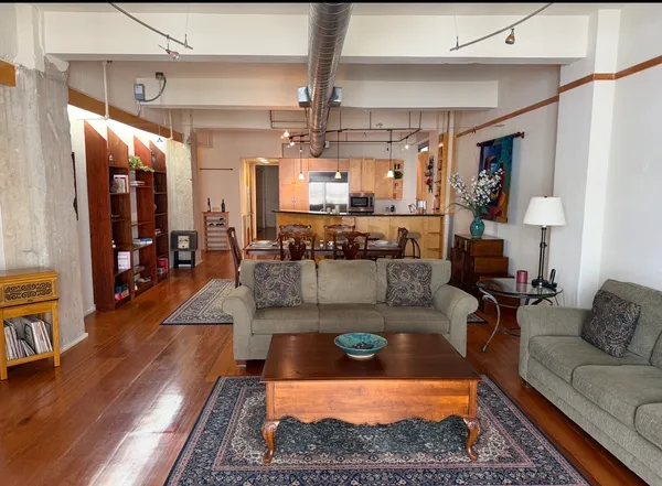 a living room with furniture and a chandelier