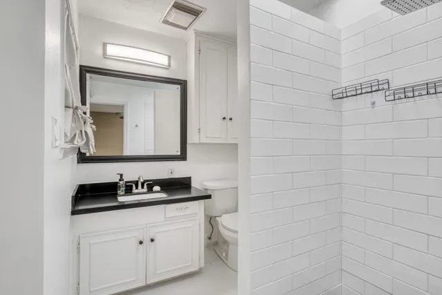 an empty room with closet and fan