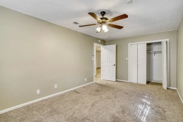 a bathroom with a granite countertop sink mirror vanity and toilet