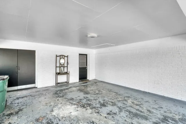 a view of an empty room with closet and window