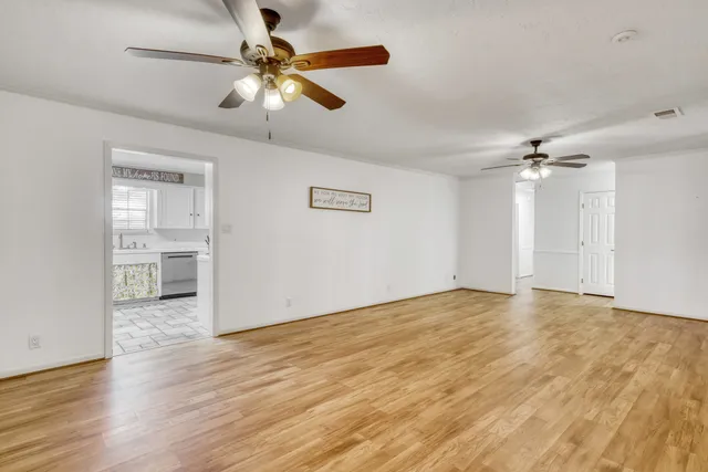 a kitchen with a sink window and cabinets