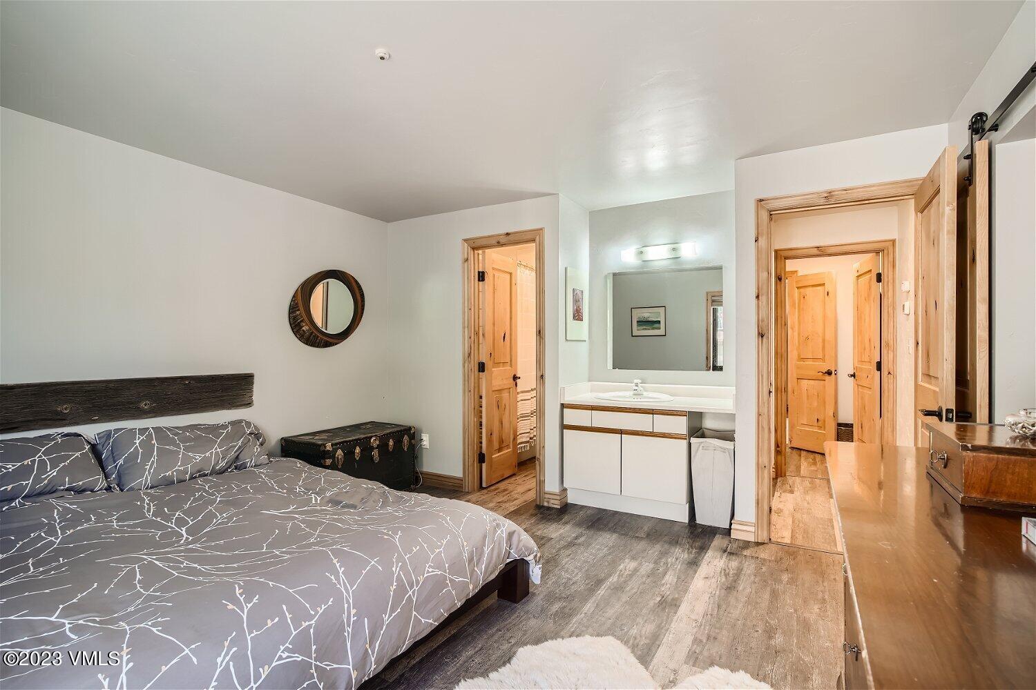 963 Lions Ridge Loop, Unit 503 Vail, CO 81657 - Photo 13 of 28 a bedroom with a bed and a chandelier