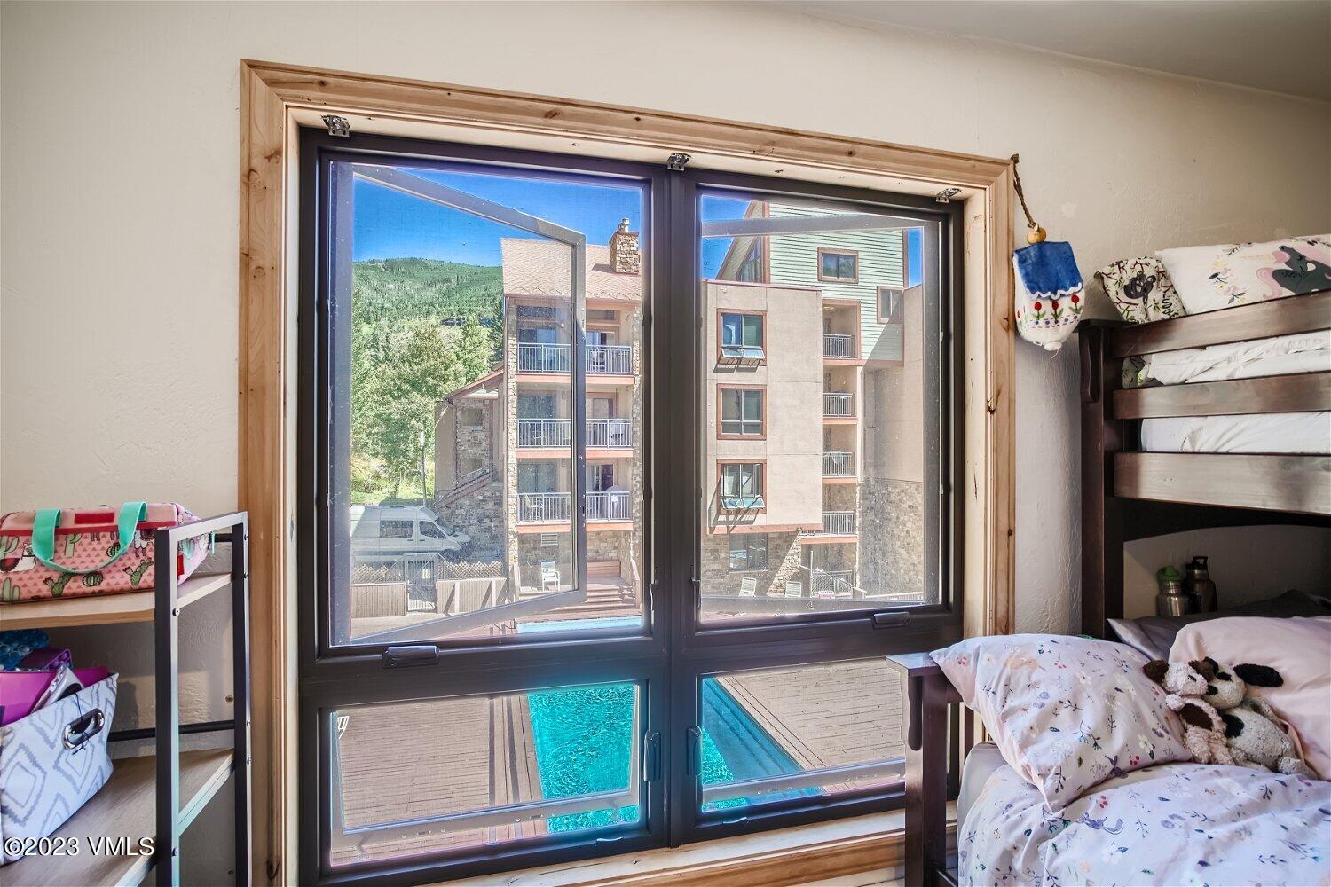 963 Lions Ridge Loop, Unit 503 Vail, CO 81657 - Photo 17 of 28 a bedroom with a bed and a window