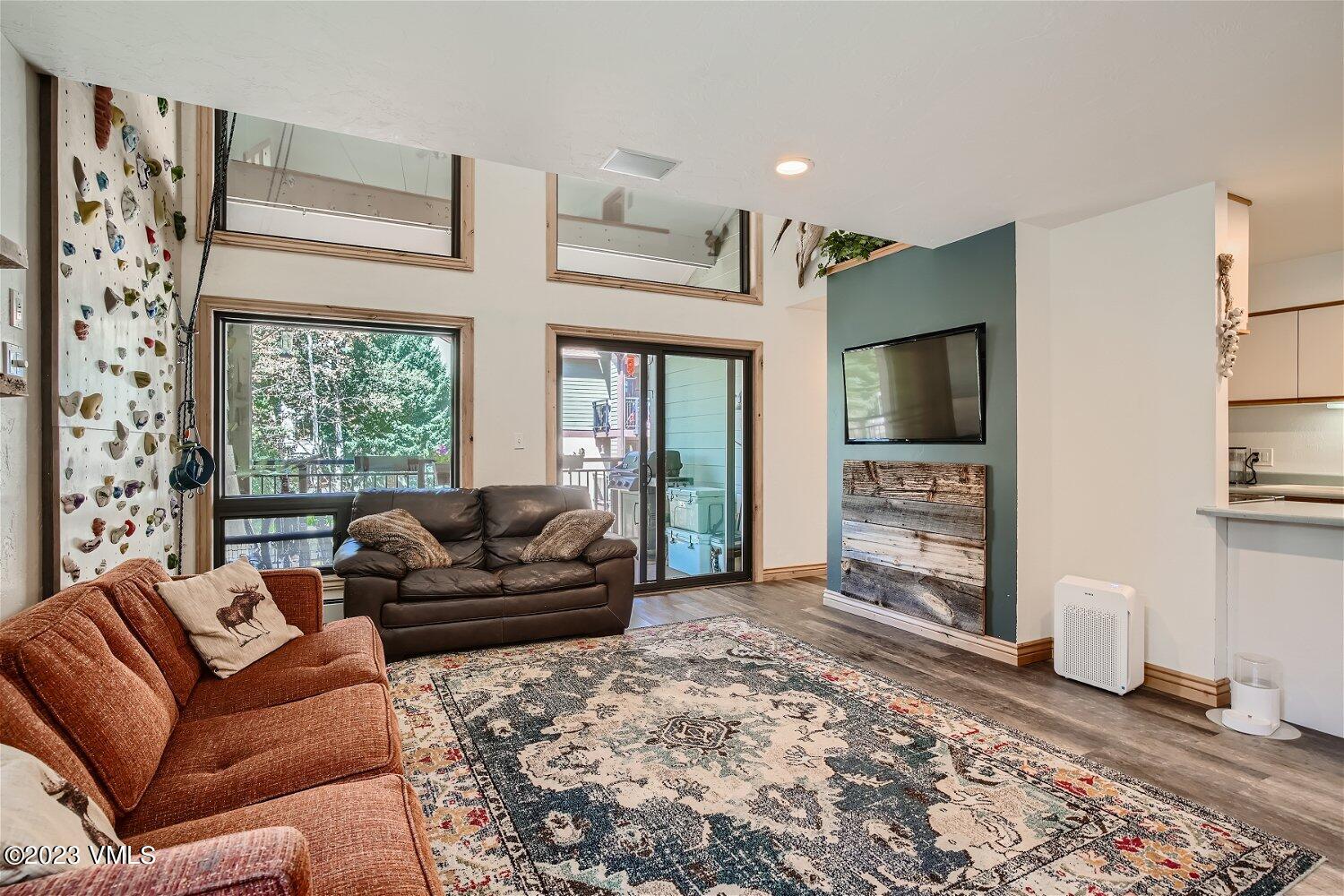 963 Lions Ridge Loop, Unit 503 Vail, CO 81657 - Photo 2 of 28 a living room with furniture and a flat screen tv