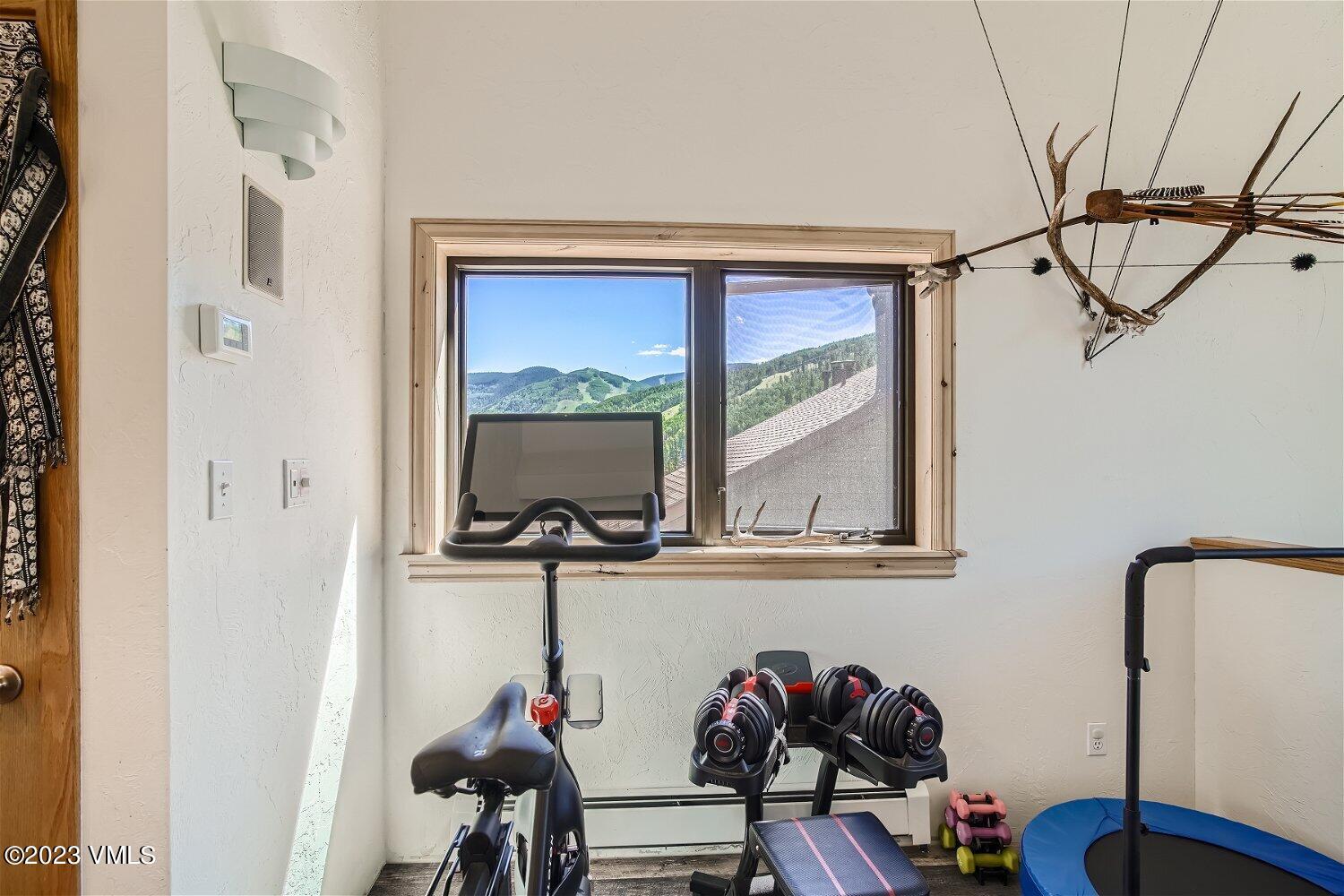 963 Lions Ridge Loop, Unit 503 Vail, CO 81657 - Photo 22 of 28 a view of hallway with table and a mirror