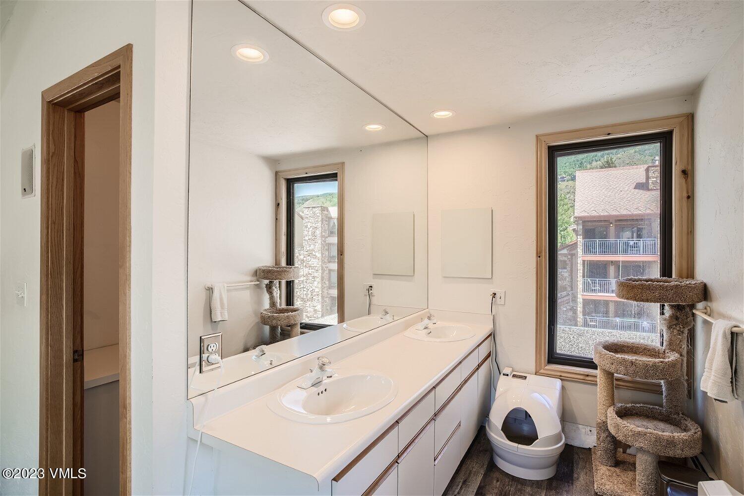 963 Lions Ridge Loop, Unit 503 Vail, CO 81657 - Photo 23 of 28 a bathroom with a sink mirror vanity and toilet