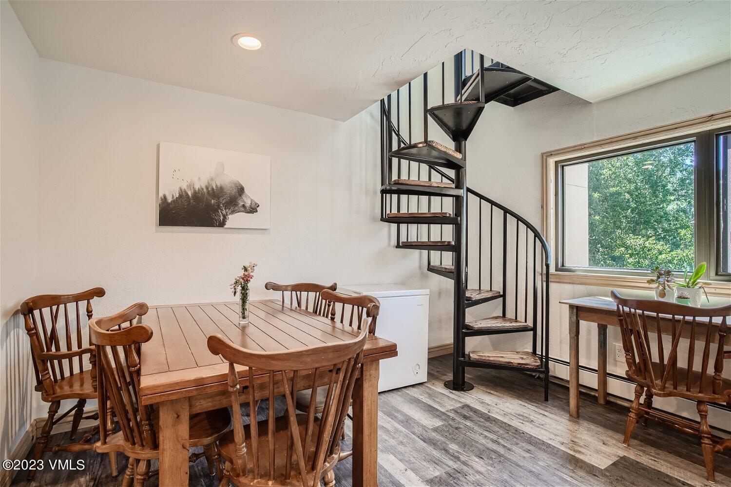 963 Lions Ridge Loop, Unit 503 Vail, CO 81657 - Photo 9 of 28 a view of a dining room with furniture window and wooden floor