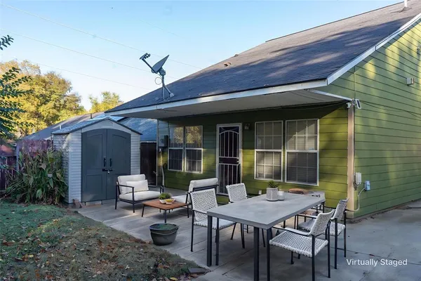 a view of a house with sitting area and garden