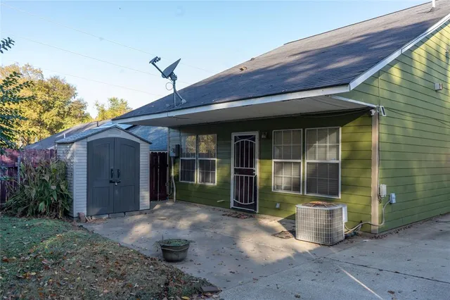 a backyard of a house with table and chairs