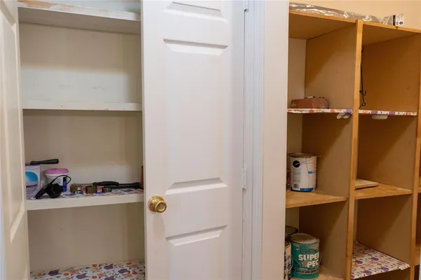 a living room with furniture kitchen view and a window