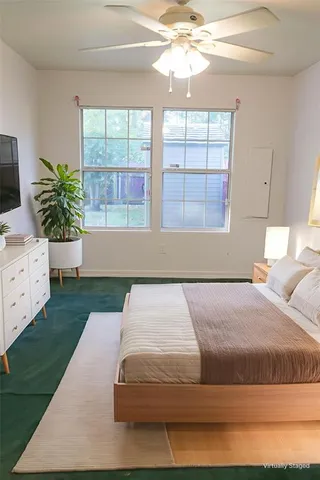 a kitchen with granite countertop a sink a window and cabinets