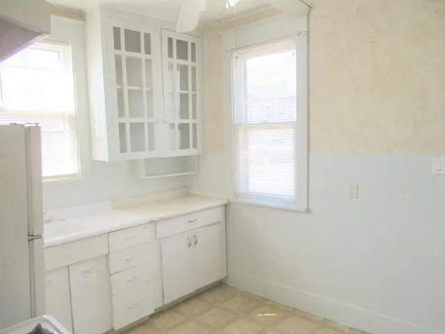 a room with a white cabinets and a window