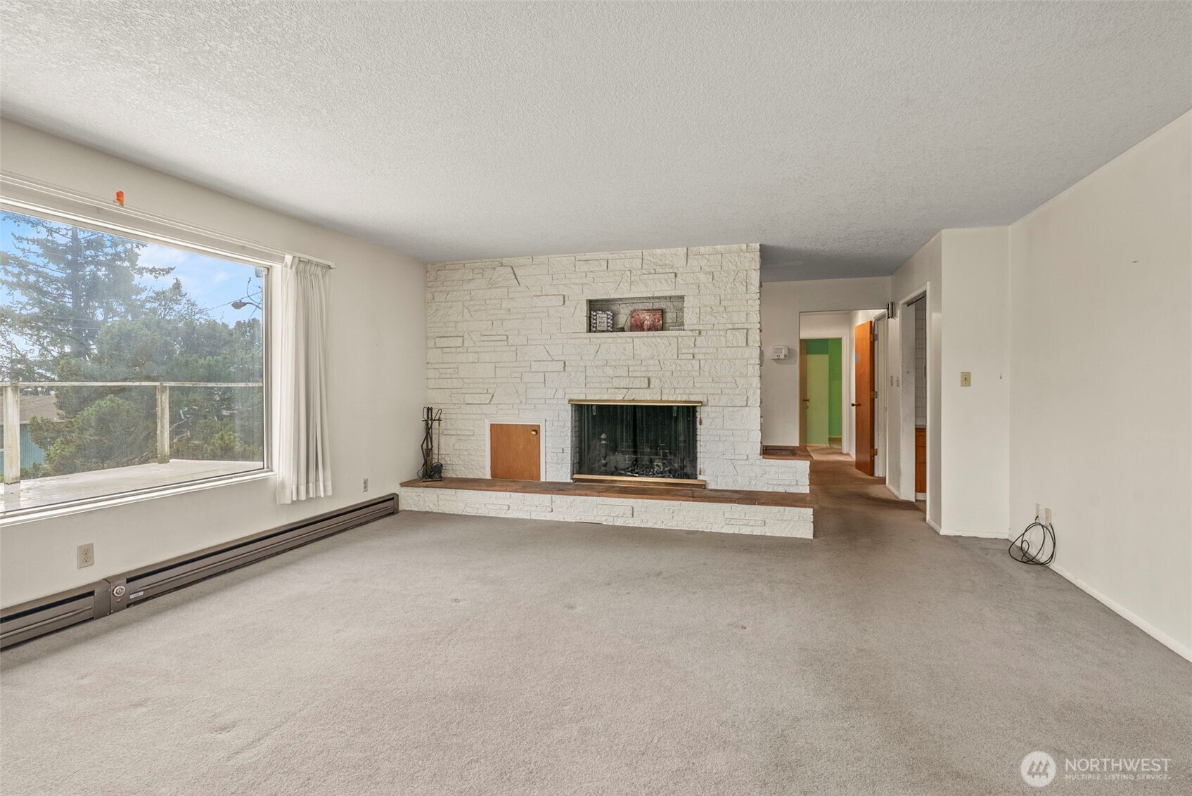 1241 Spruce Street Longview, WA 98632 - Photo 12 of 26 an empty room with furniture and a fireplace