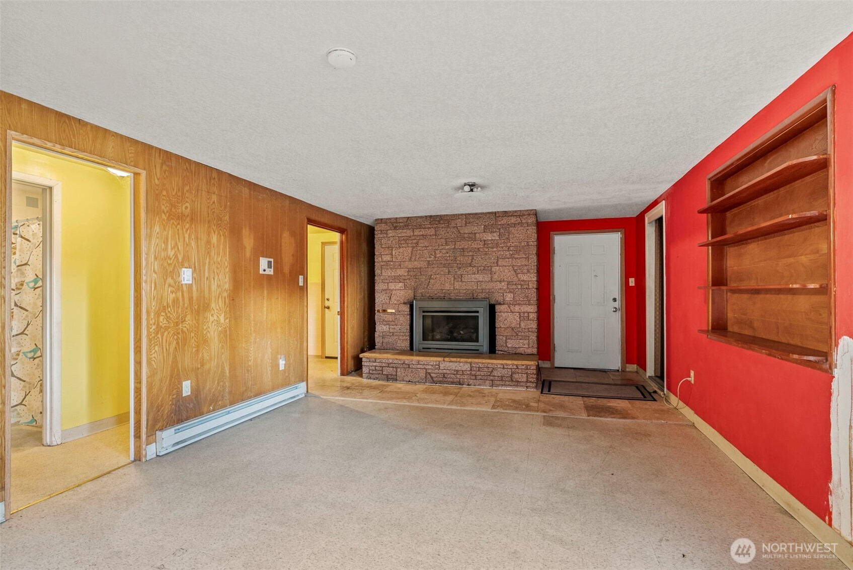 1241 Spruce Street Longview, WA 98632 - Photo 7 of 26 a view of an empty room with a fireplace and a window