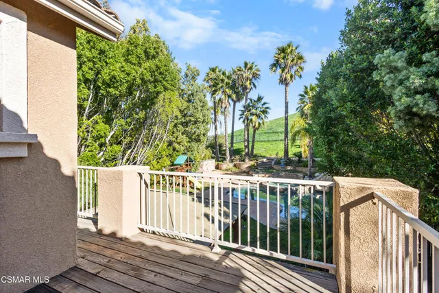 a view of a wooden deck and a backyard
