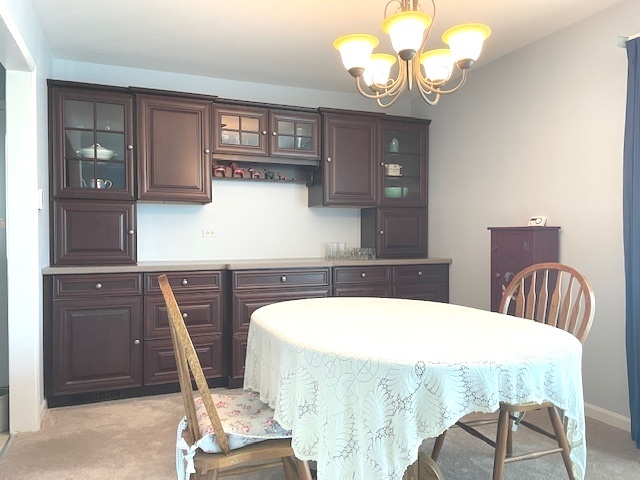 6118 Meyer Road Marengo, IL 60152 - Photo 6 of 42 a bathroom with a sink a mirror and a chandelier