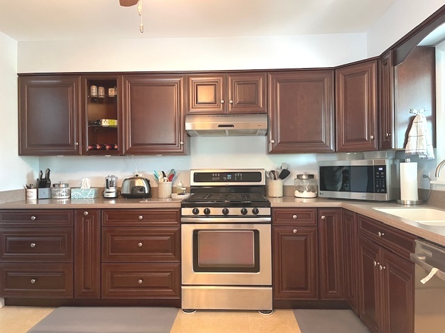 6118 Meyer Road Marengo, IL 60152 - Photo 10 of 42 a kitchen with stainless steel appliances granite countertop a stove and cabinets