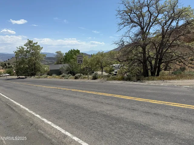 a view of a yard with wooden fence