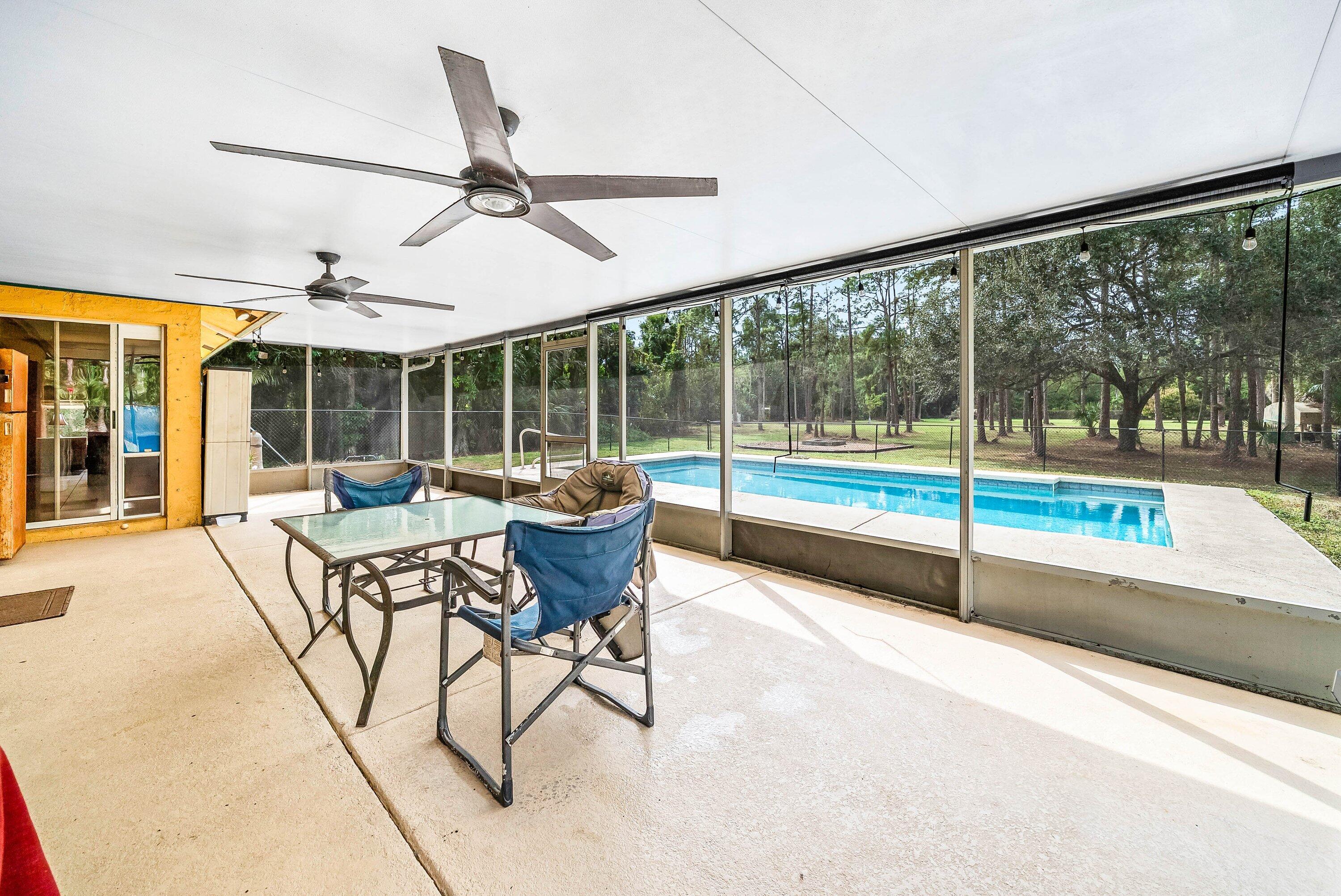 2195 F Road Loxahatchee Groves, FL 33470 - Photo 20 of 54 a view of a dining room with furniture window and outside view