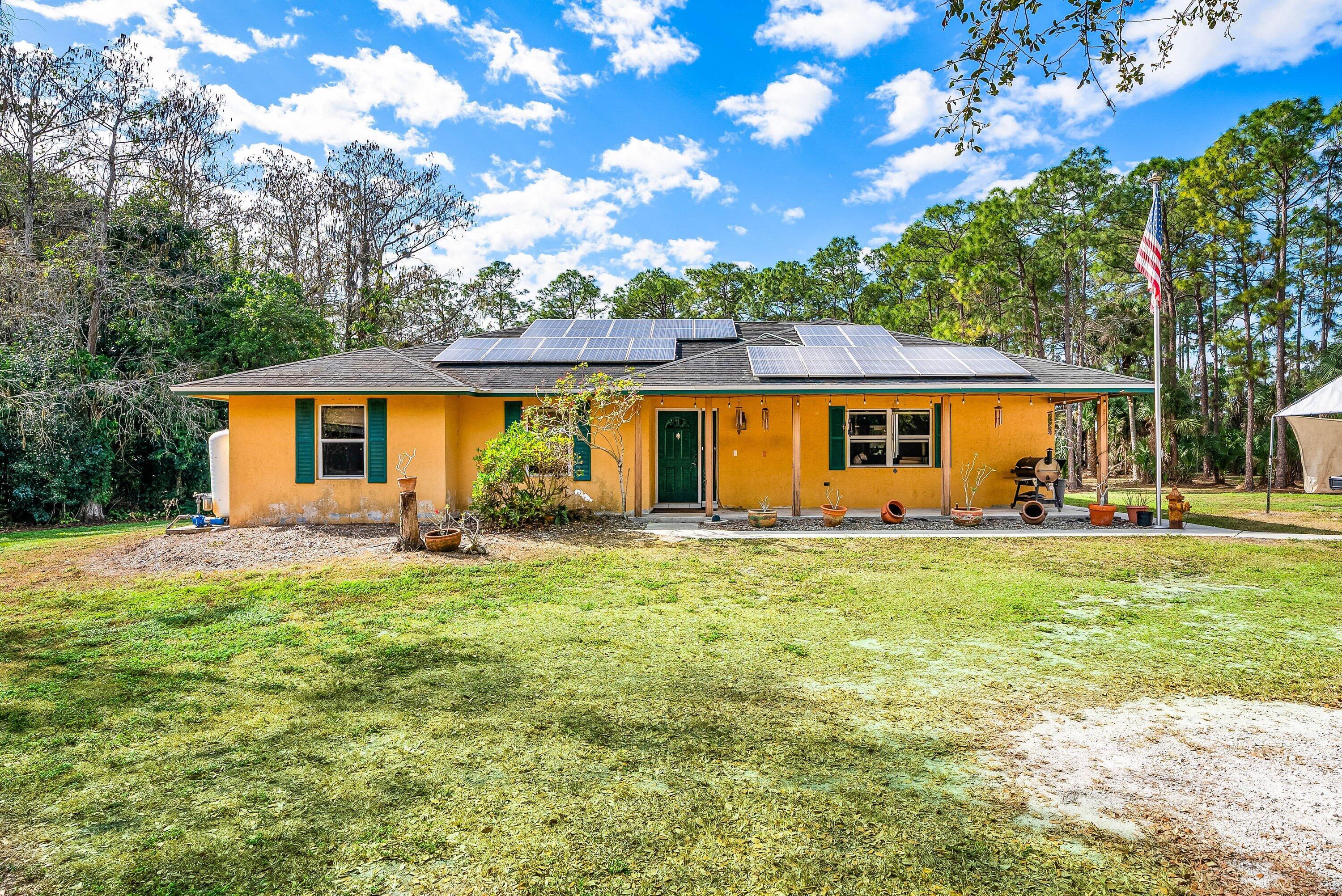 2195 F Road Loxahatchee Groves, FL 33470 - Photo 2 of 54 a view of a house with a backyard