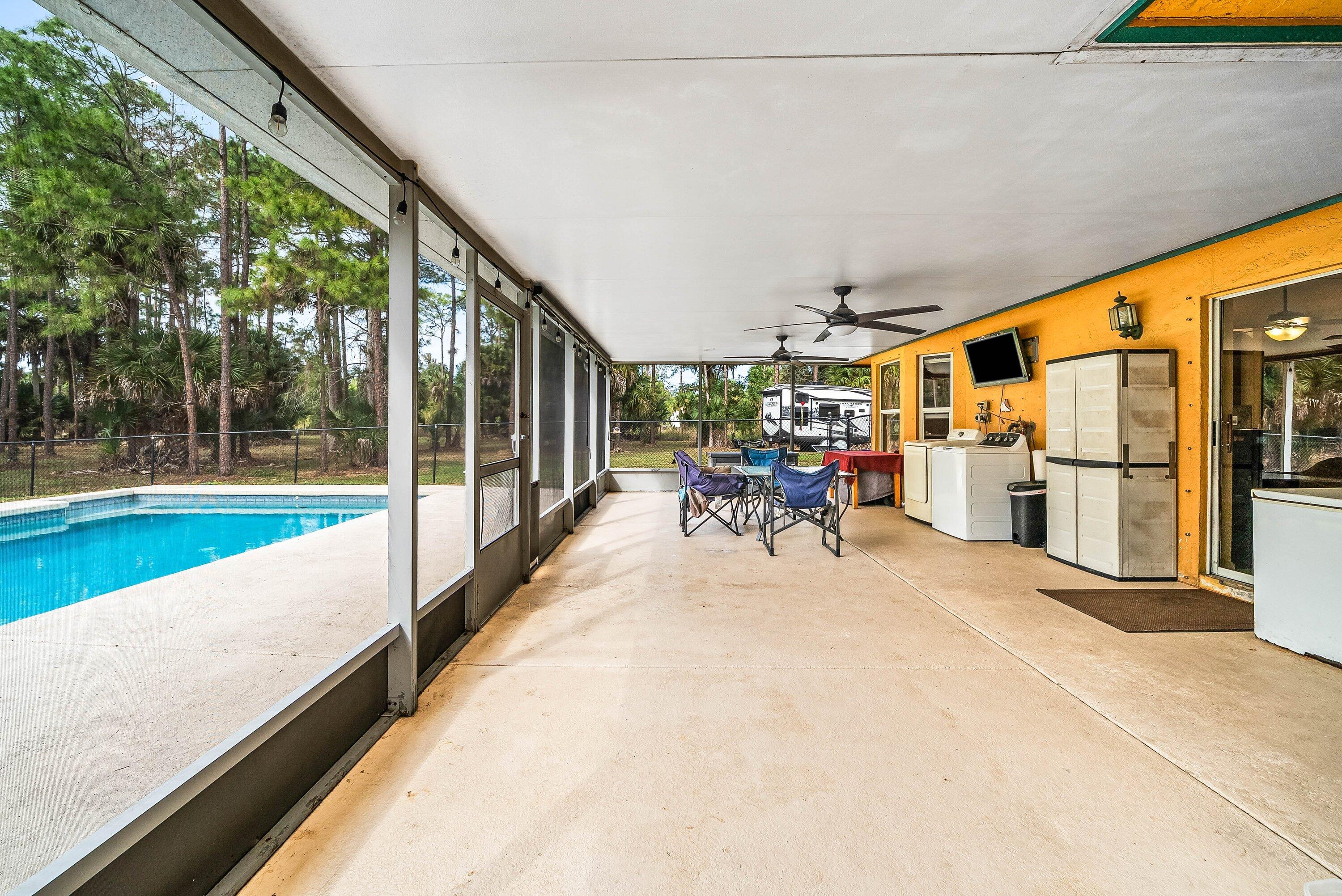2195 F Road Loxahatchee Groves, FL 33470 - Photo 22 of 54 a view of a patio with a table and chairs