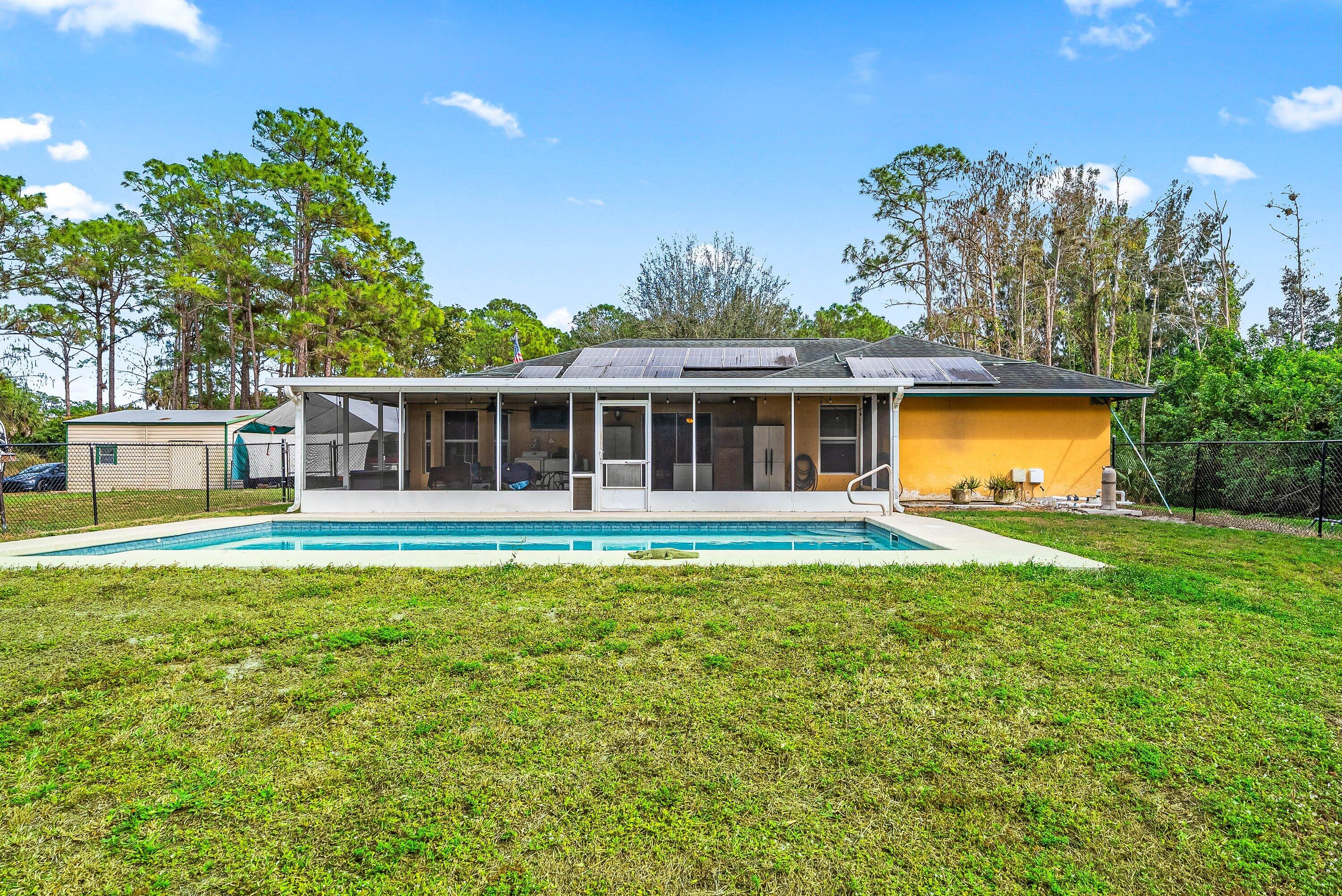 2195 F Road Loxahatchee Groves, FL 33470 - Photo 25 of 54 a front view of house with yard and seating area
